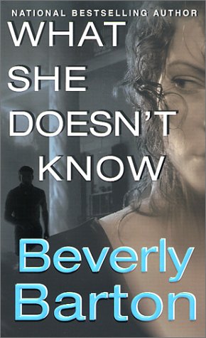 cover image WHAT SHE DOESN'T KNOW