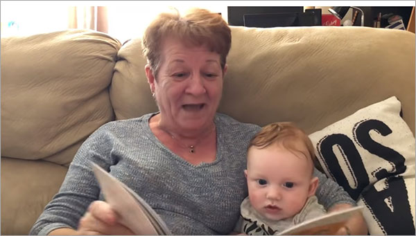 grandma reads book to baby